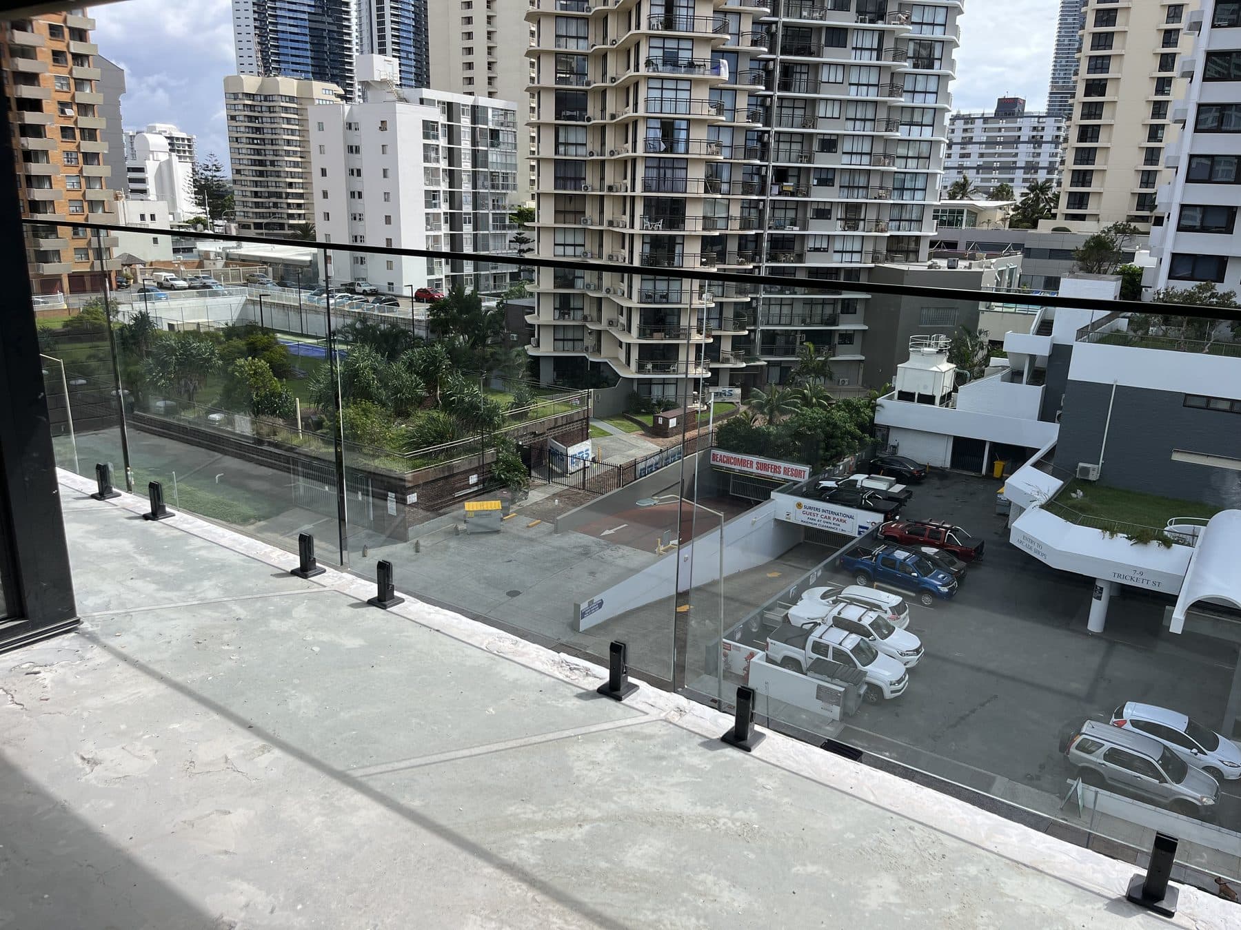 Frameless glass balustrade on a Gold Coast balcony overlooking the high-rise skyline